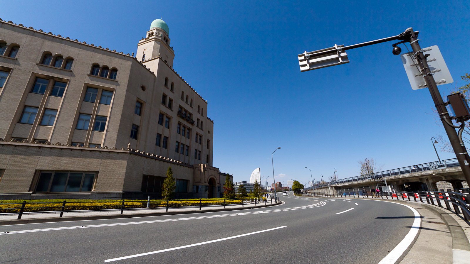 The Yokohama Customs headquarters and its green-domed tower beside a broad city road.
