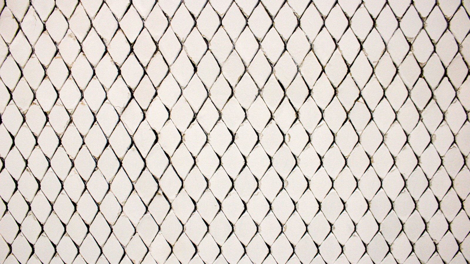 A flat photograph of small off-white ceramic tiles set in a diamond lattice, filling the whole frame edge to edge, each facet slightly uneven and separated by fine grey grout lines, with no perspective, edge, fitting or object visible. No text, marking, brand, person or place is in view. A generic surface close-up, not a photograph of any ministry, market or document.