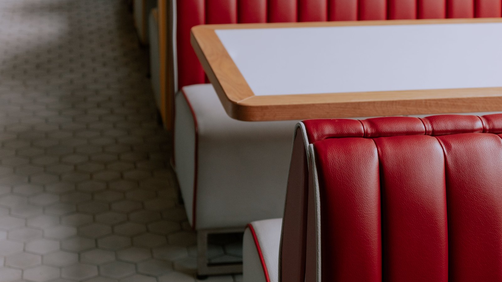 Empty red diner booths and white tabletops, a generic stock photograph and not Joe's Diner.