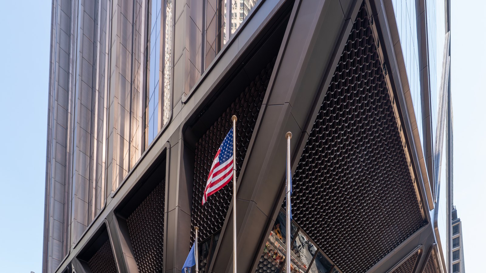 Angled steel supports and flags at the Park Avenue entrance of JPMorgan Chase headquarters.