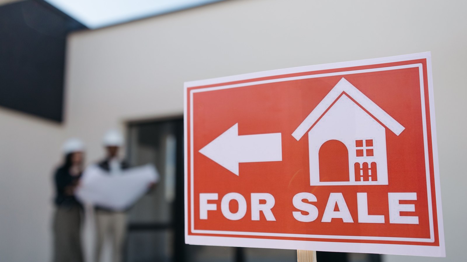 A photograph illustrating for sale sign house.