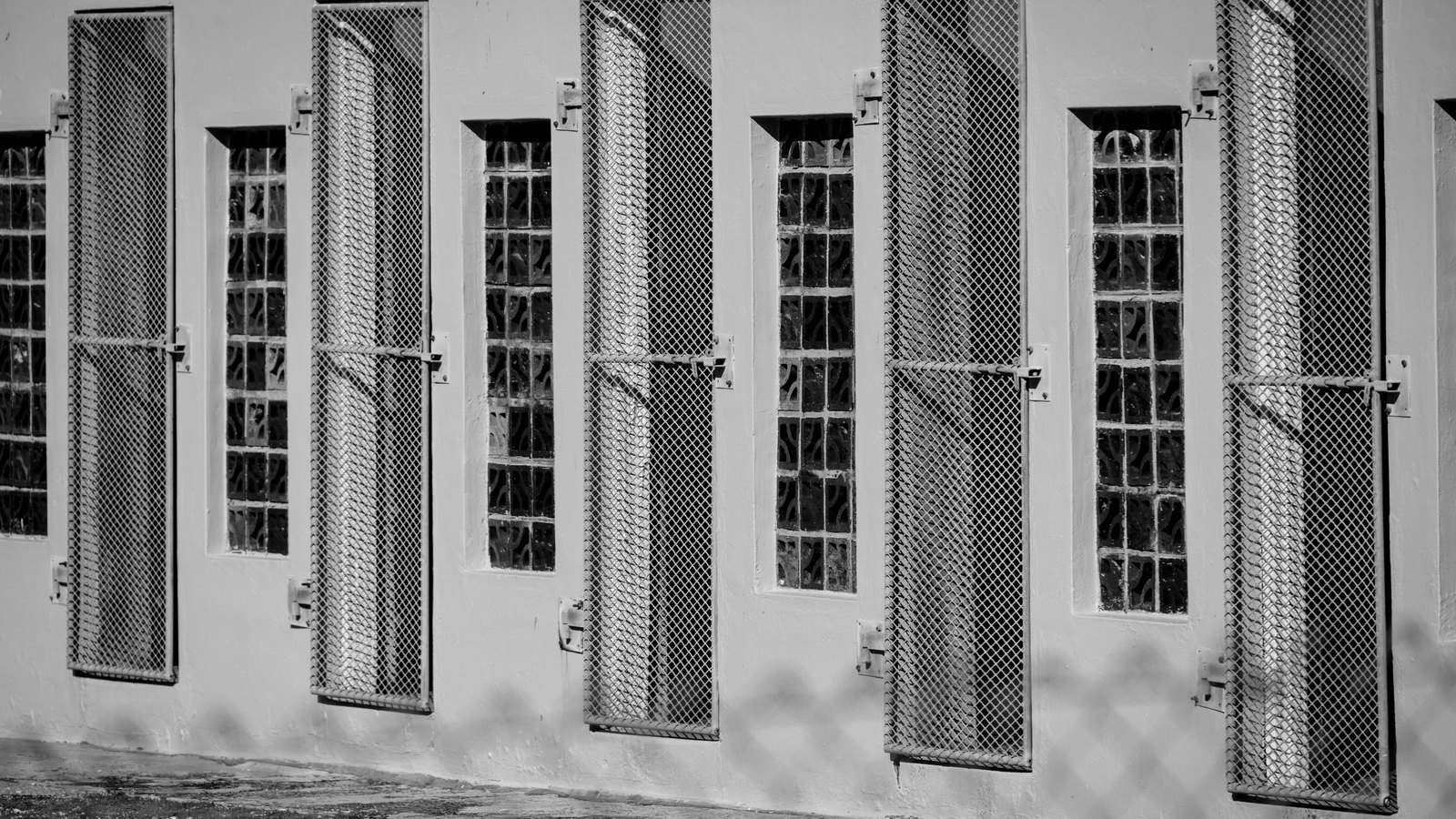 A row of barred windows on an empty institutional building, not a photograph of this case or a Lee County facility.