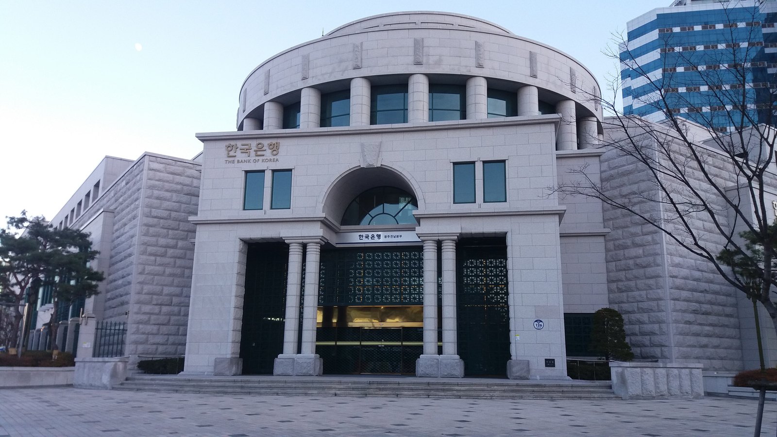The Bank of Korea's Gwangju branch, a pale stone building with a round upper storey and the bank's name above the entrance.