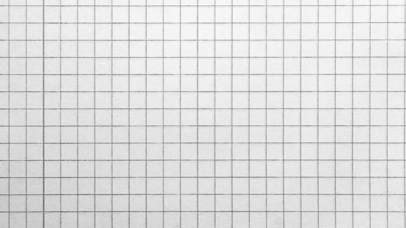 A sheet of graph paper filling the frame, its fine grey grid ruled evenly across a plain white surface.