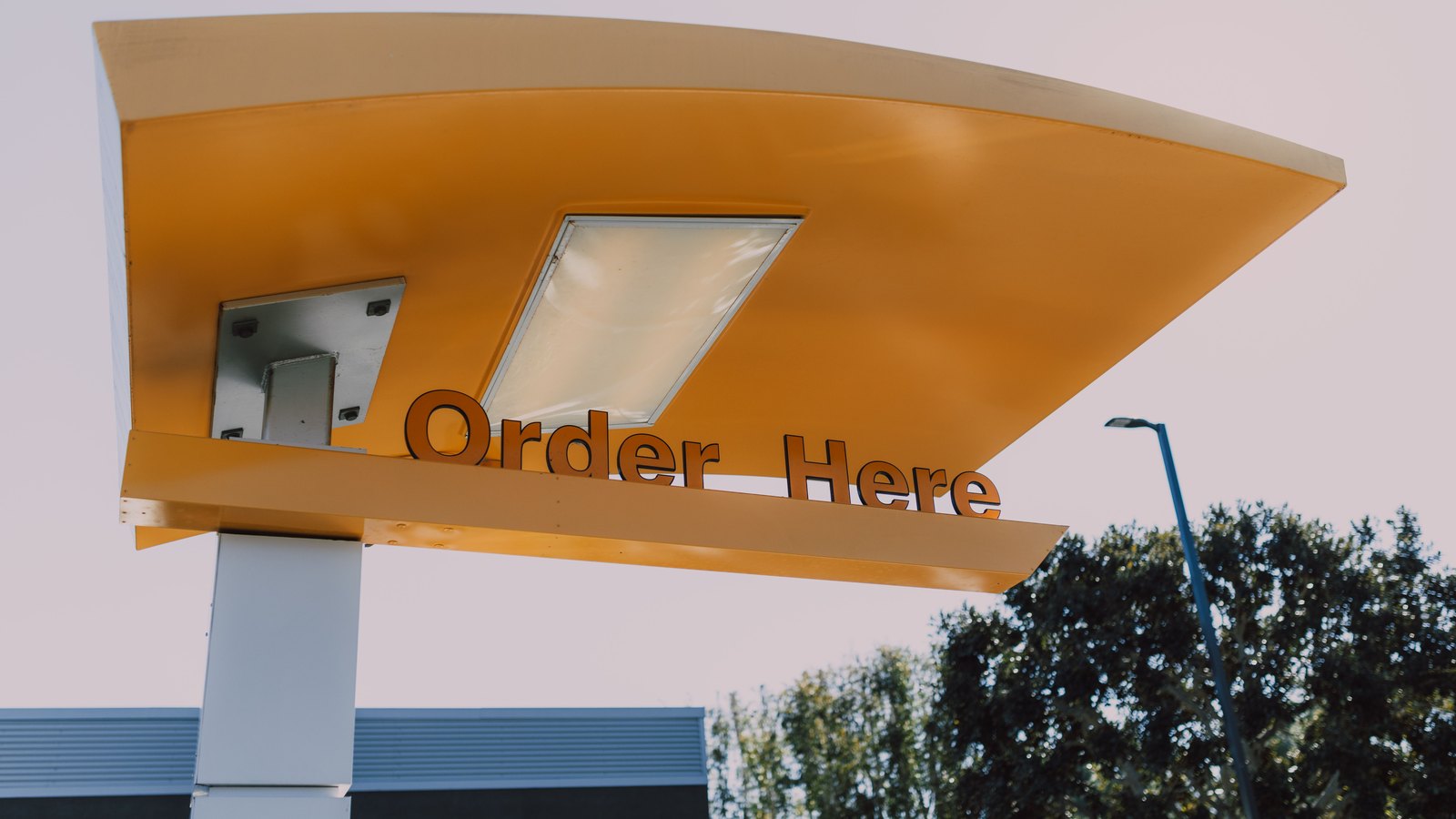 A generic drive-through order canopy against the sky. Stock photo, not the Lehigh Acres restaurant.