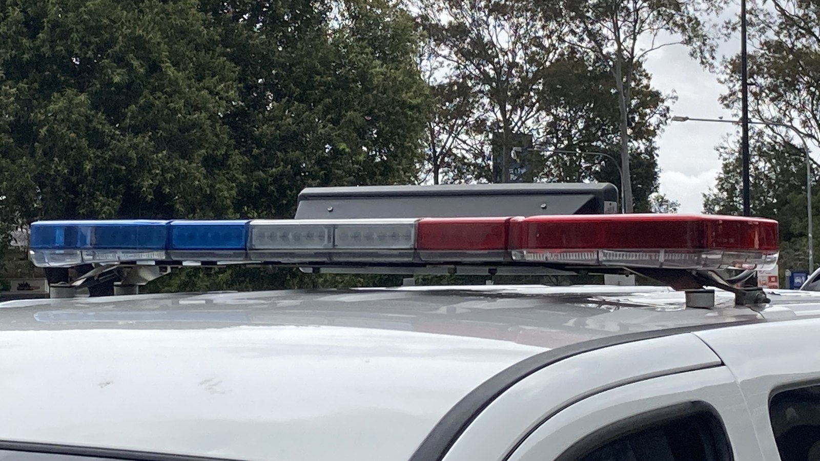 A red and blue emergency-vehicle light bar photographed at close range.