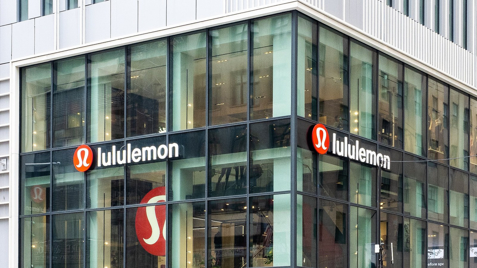 A Lululemon store facade with the company name above its windows.