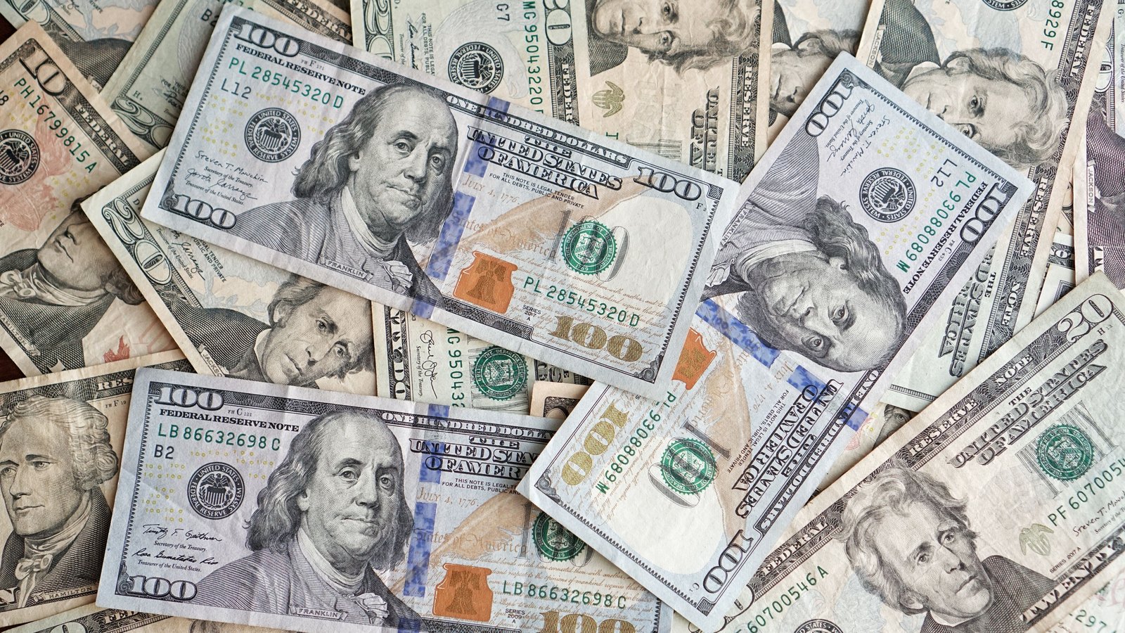Assorted United States dollar banknotes arranged in a pile