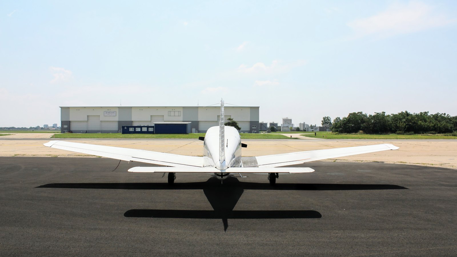A small single-engine airplane sits on a generic airport apron, not a photograph of this event.