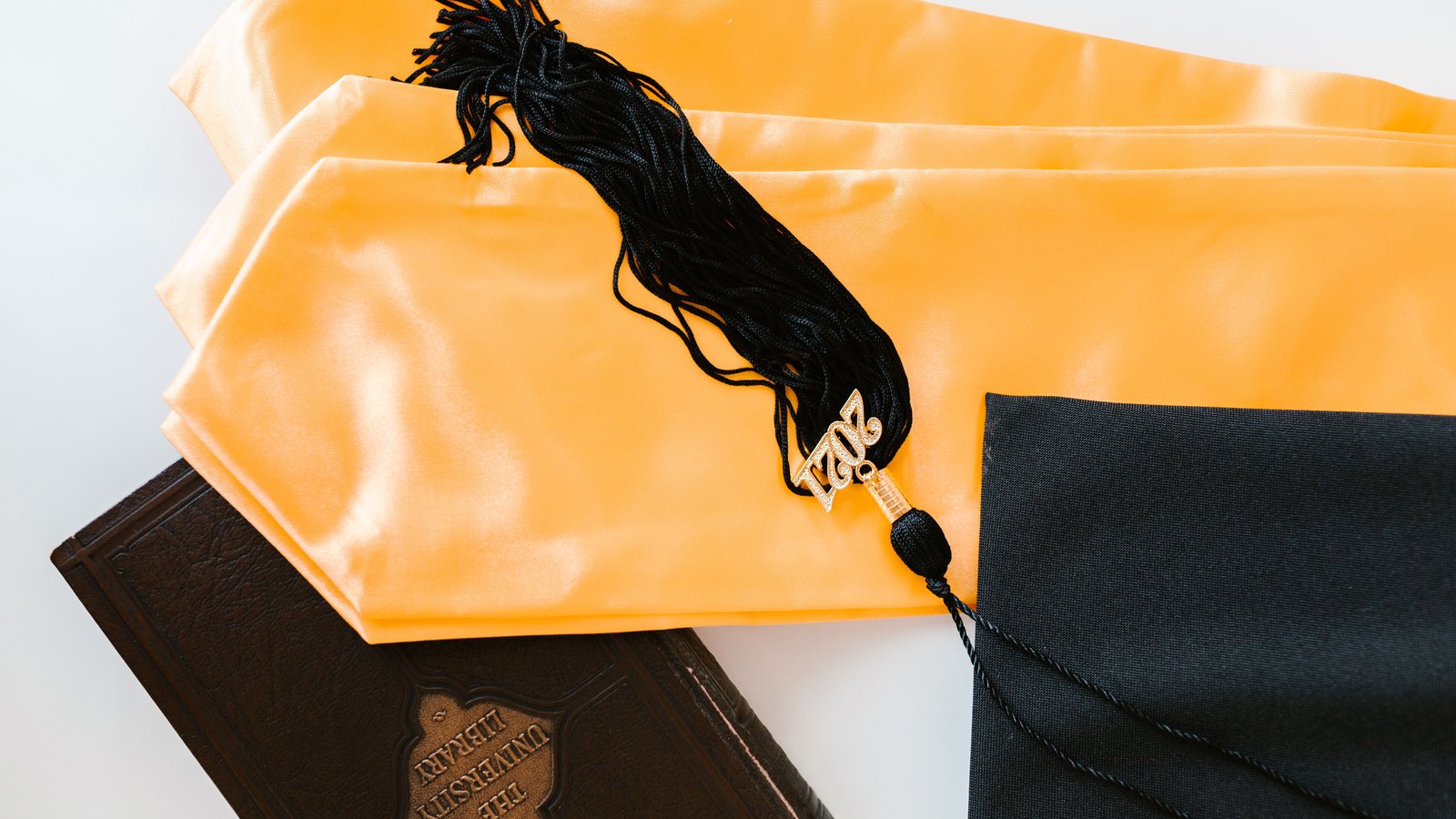 A photograph illustrating graduation cap books.
