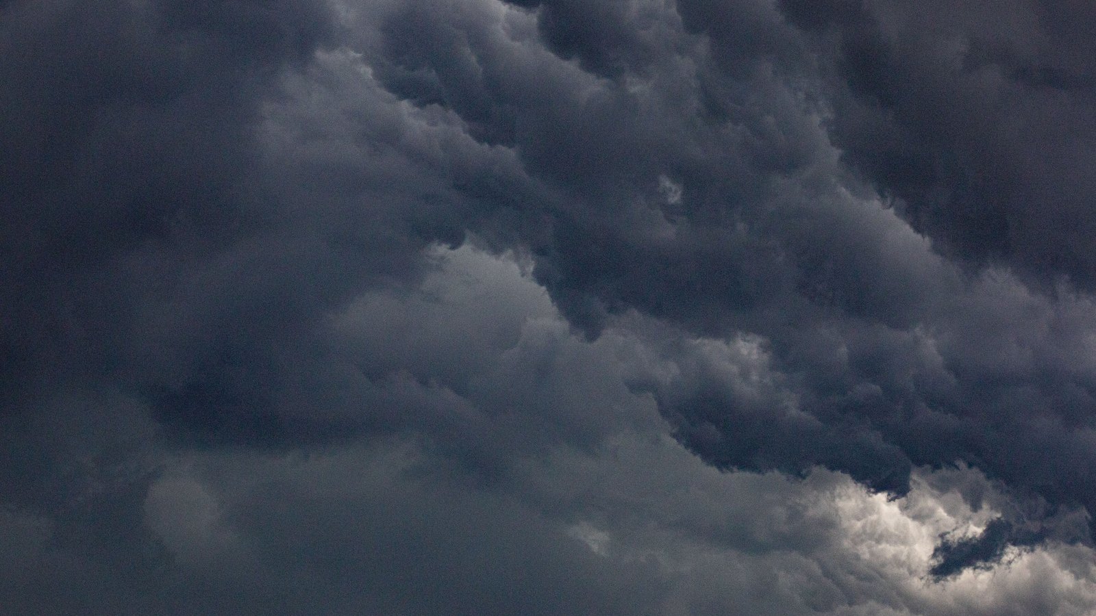 Dense dark thunderstorm clouds fill the sky; not a photograph of this event.