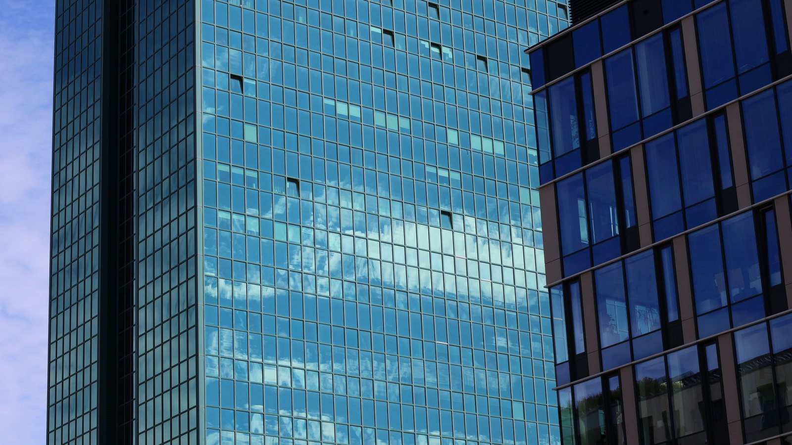 A photograph illustrating glass office tower facade.