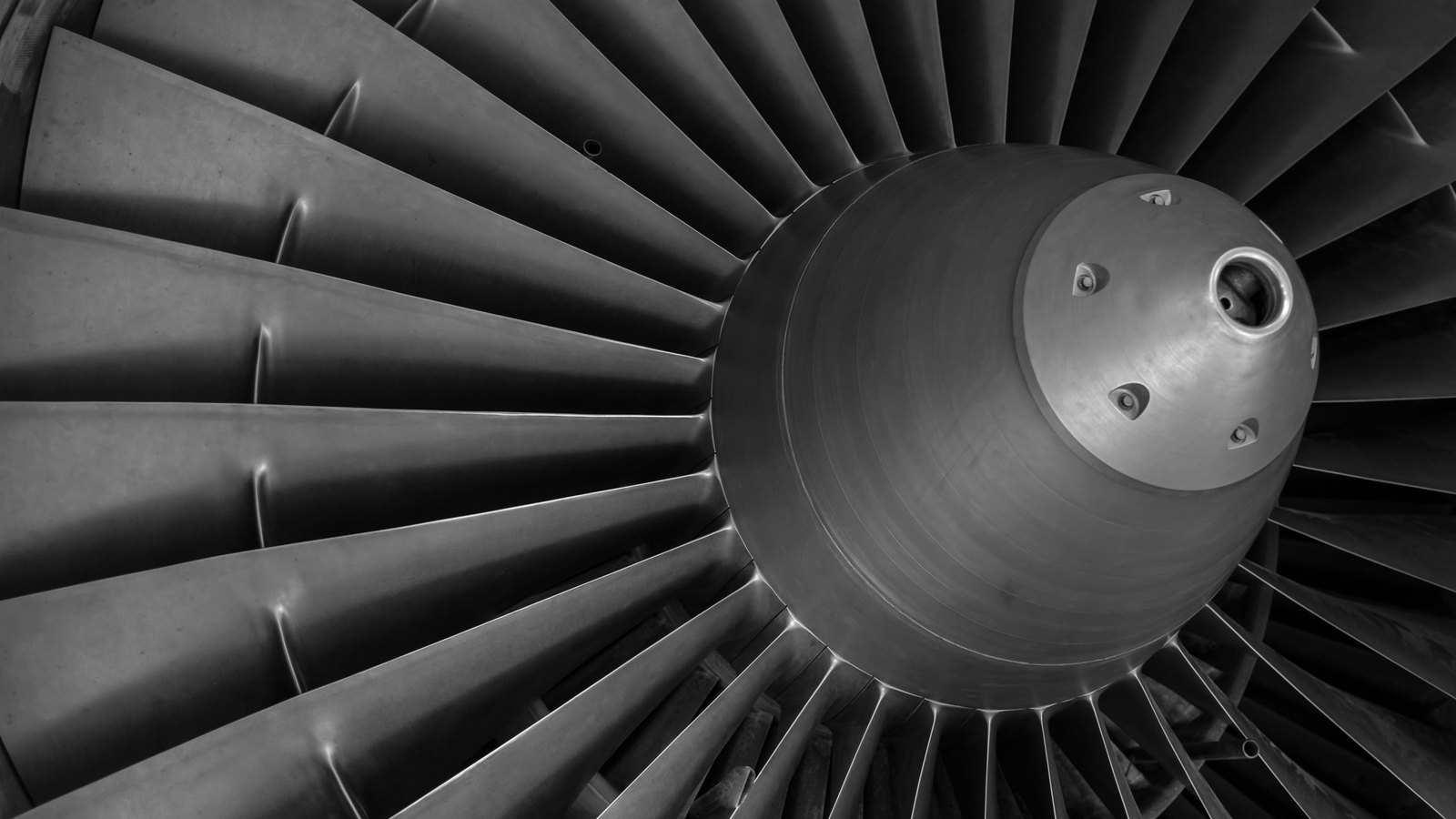 A photograph illustrating jet engine turbine blades closeup.