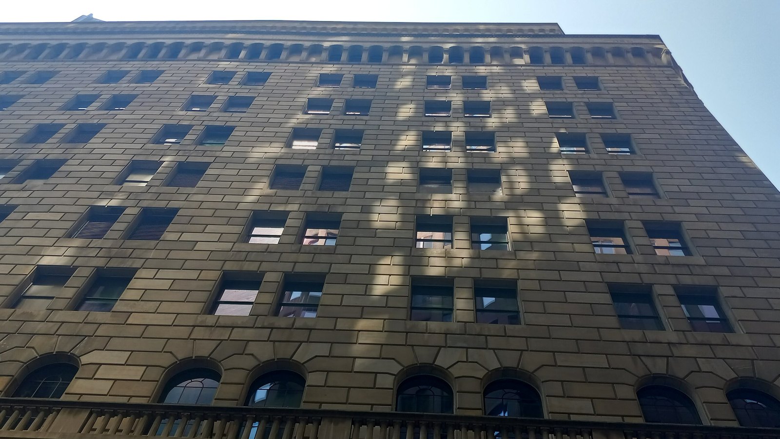 The stone facade of the Federal Reserve Bank of New York building.