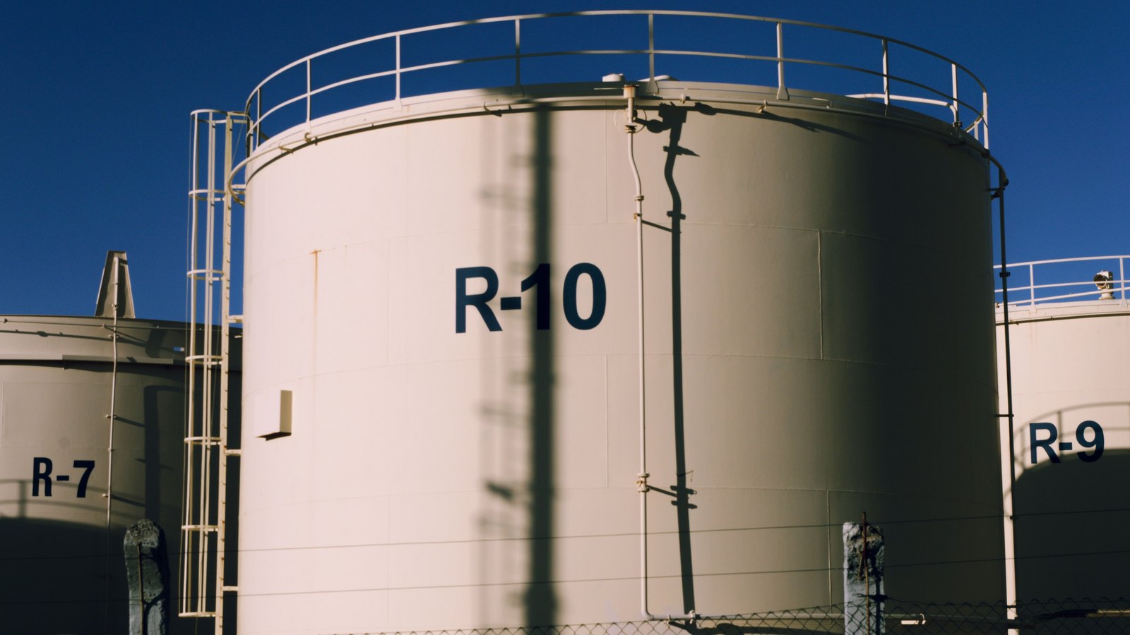 A photograph illustrating crude oil storage tanks.