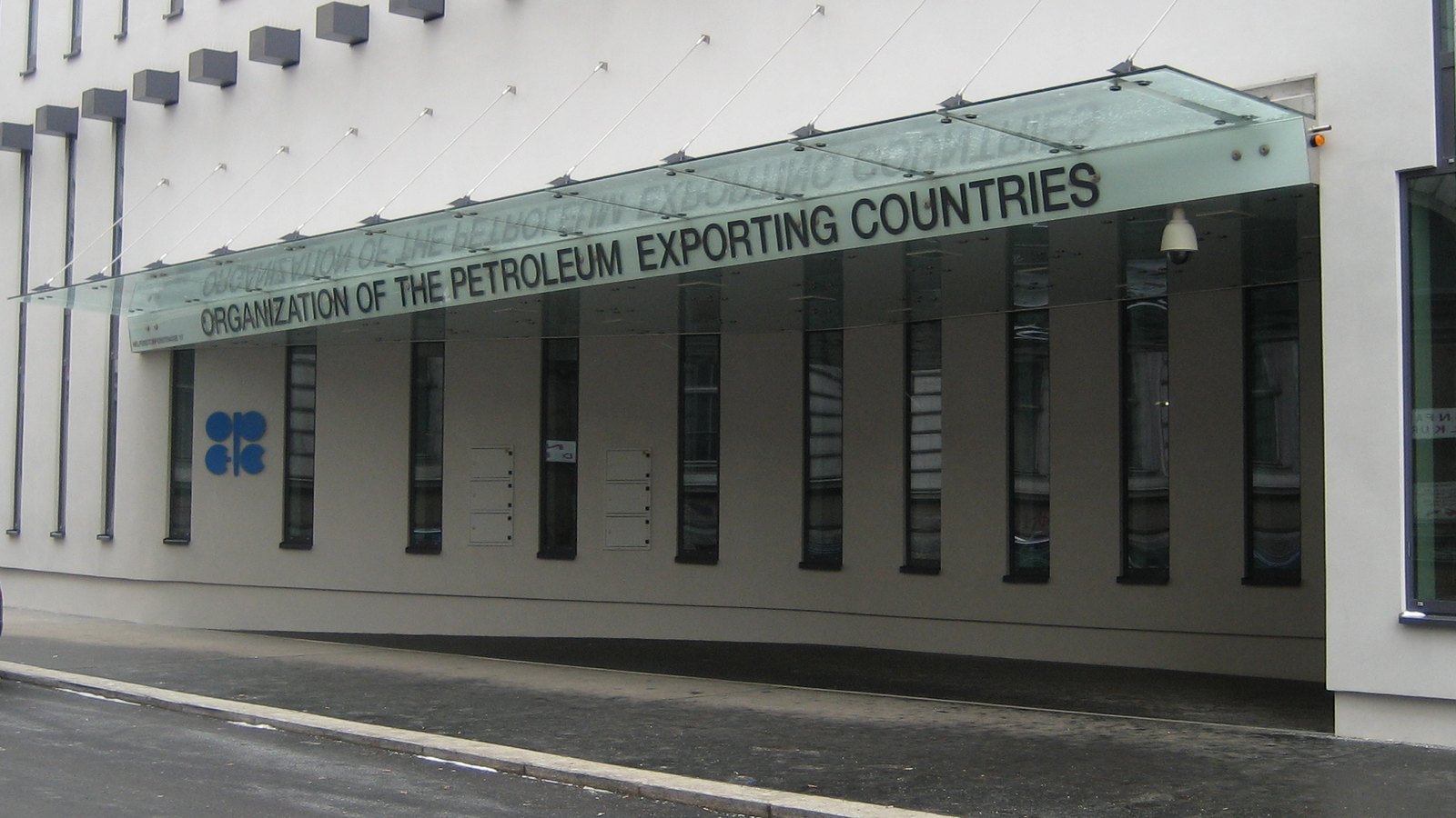 The entrance canopy at OPEC headquarters in Vienna, with the organization name and logo on the building.