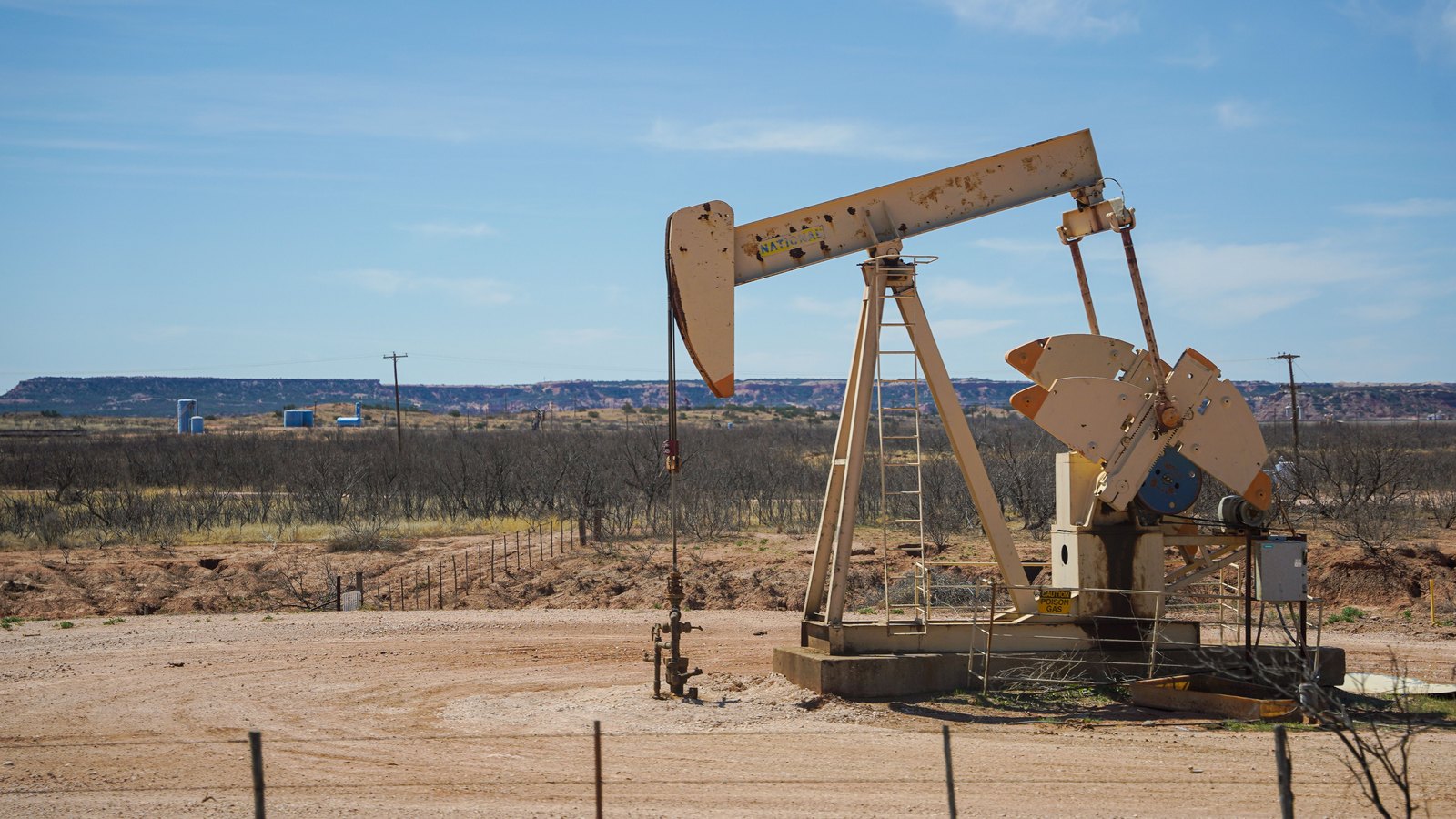 A photograph illustrating oil pumpjack desert.