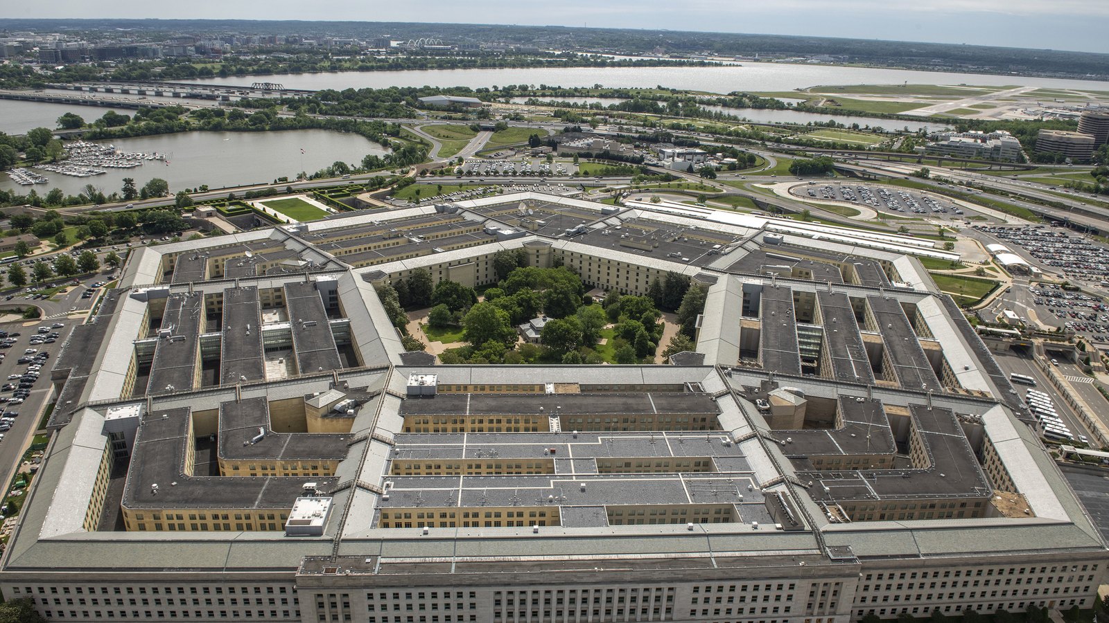 A close aerial view of the Pentagon with the Potomac River and airport behind it.