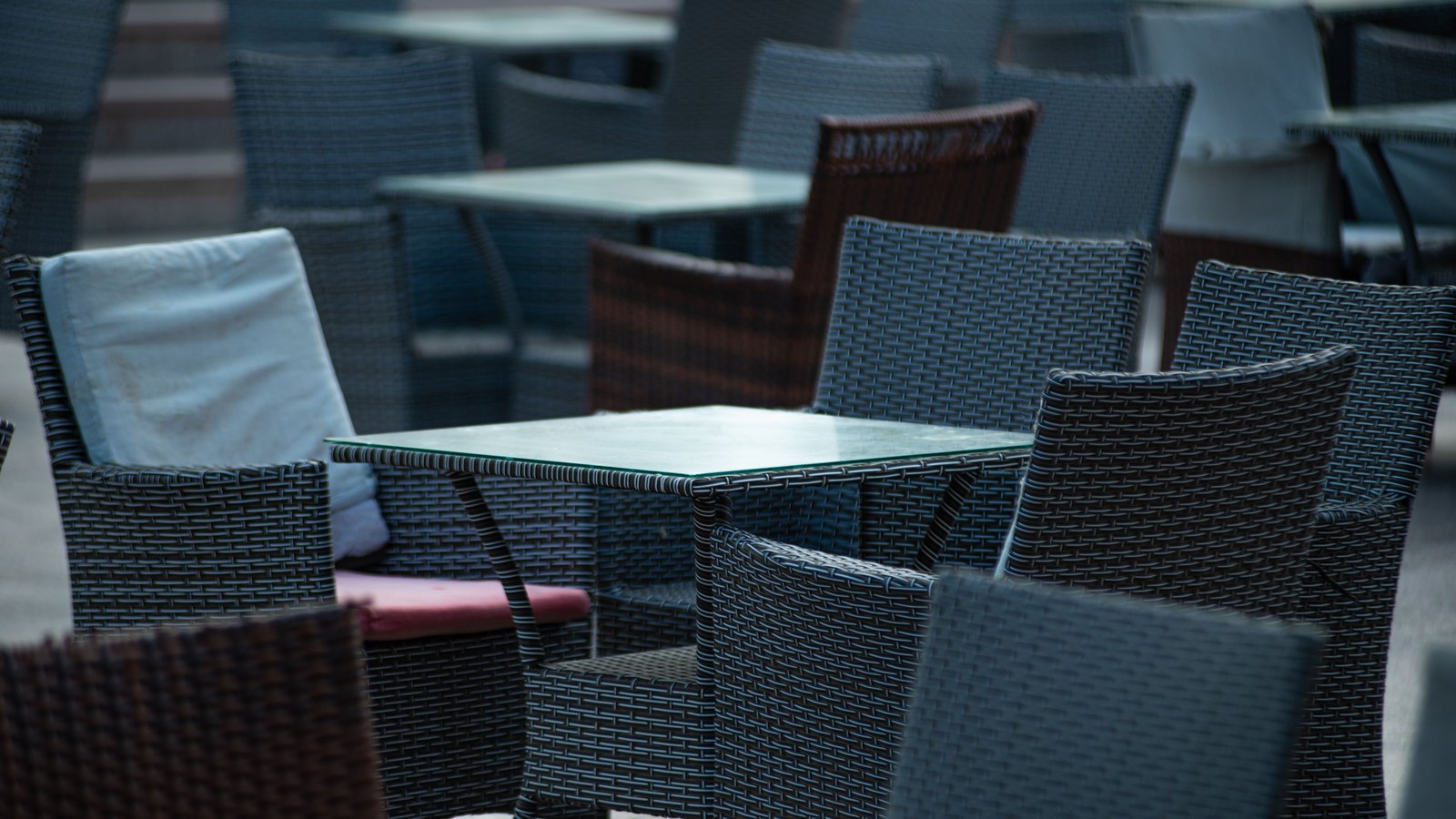 Empty cafe tables and chairs, not a photograph of the businesses surveyed.