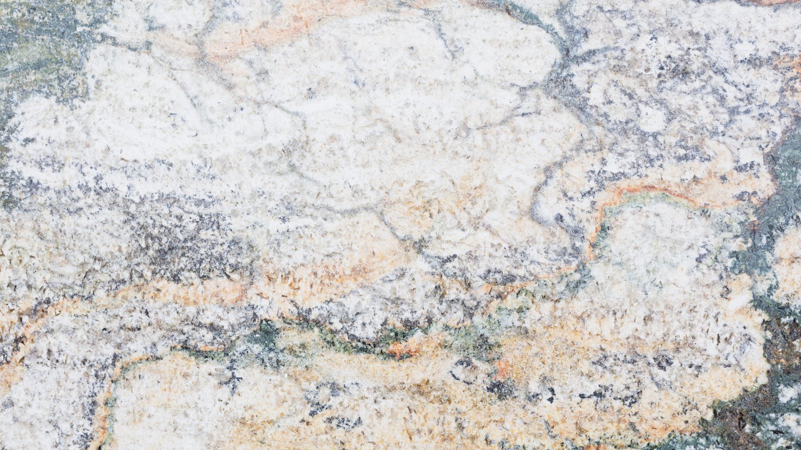 A pale polished stone surface filling the frame. Cream and white areas are broken by grey mottling and by thin veins of orange and green grey wandering across the slab. No lettering, edges or objects are visible.