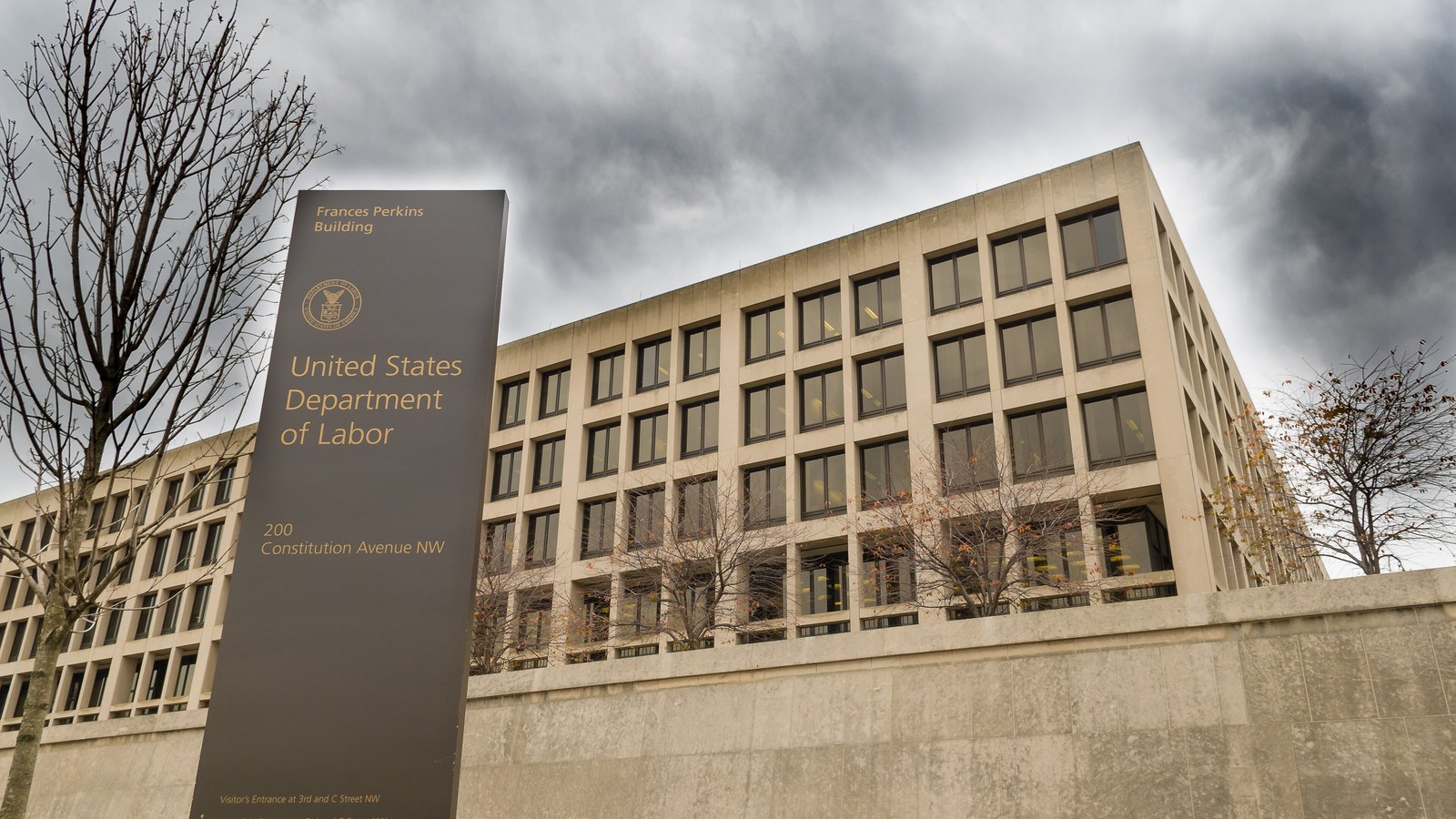 A sign identifies the Frances Perkins Building as the United States Department of Labor headquarters in Washington.