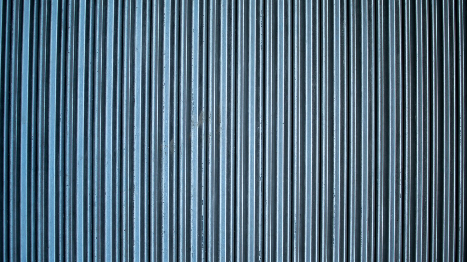 A photograph illustrating dense grid of square glass blocks in a wall filling the entire frame macro.