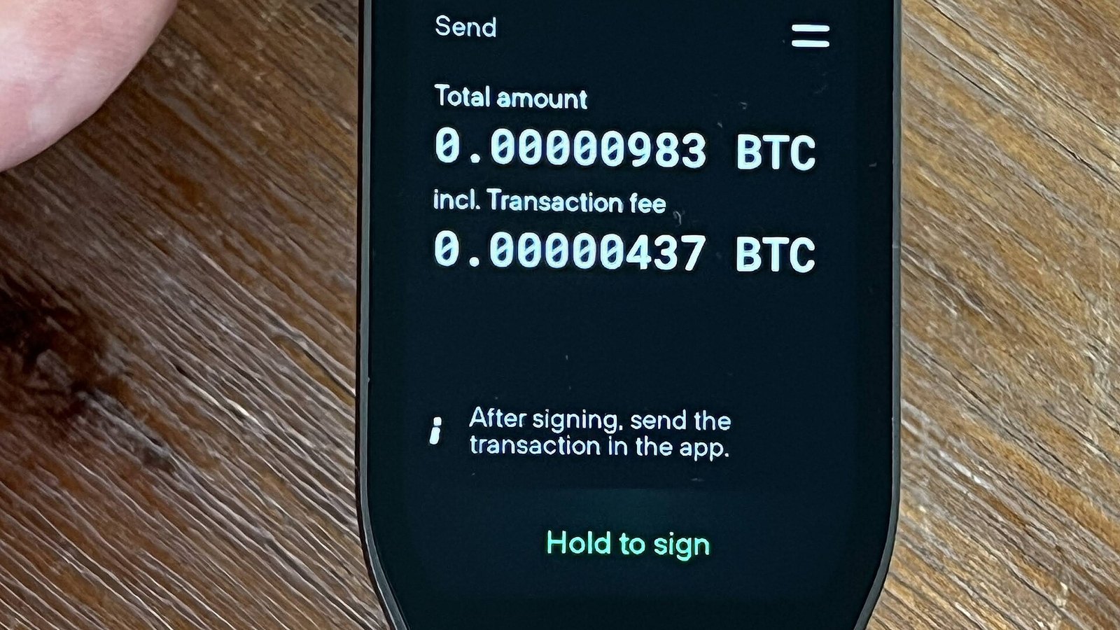 A hardware wallet displays a Bitcoin transaction for approval.