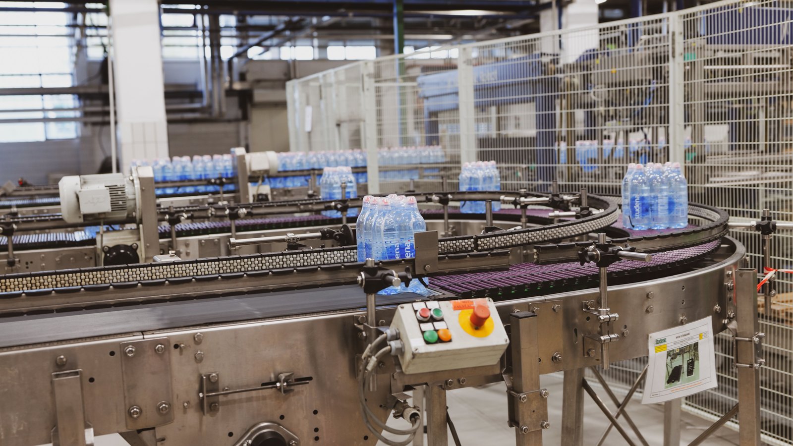 Bottled water moves through an automated factory production line
