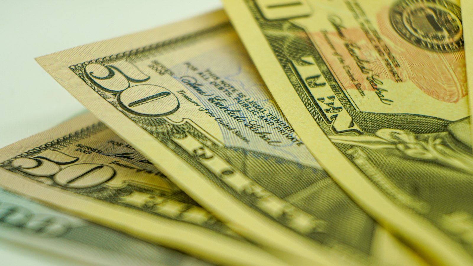 United States dollar banknotes shown in close detail.