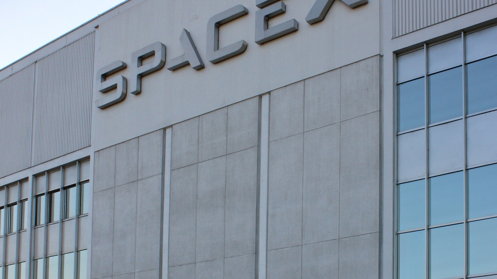 The SpaceX logo on the facade of its headquarters in Hawthorne, California.