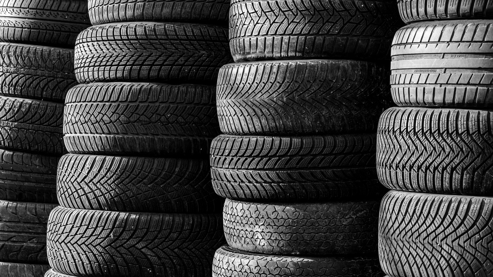 A photograph illustrating stacked rubber tires.