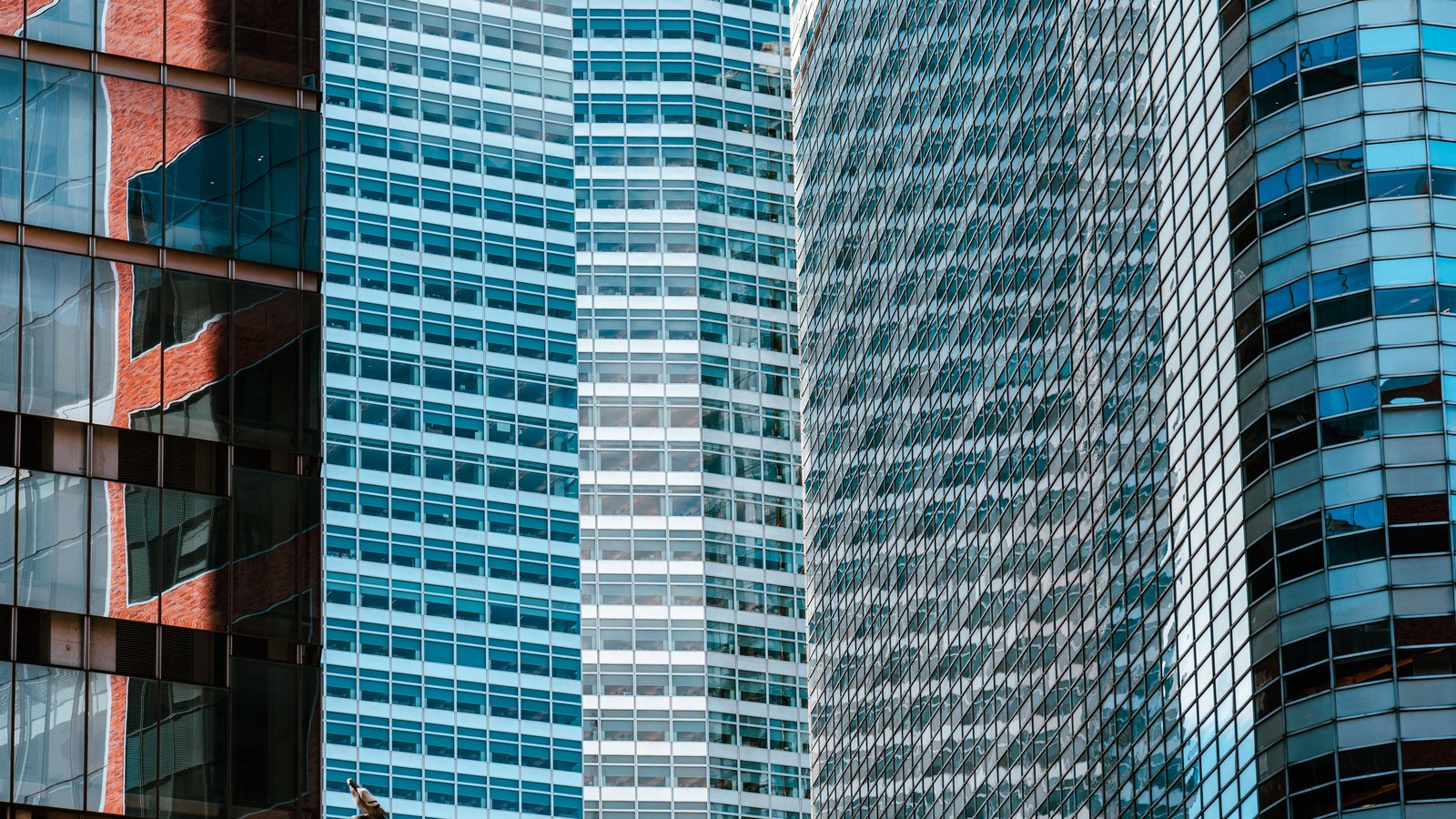 A photograph illustrating office tower glass facade.