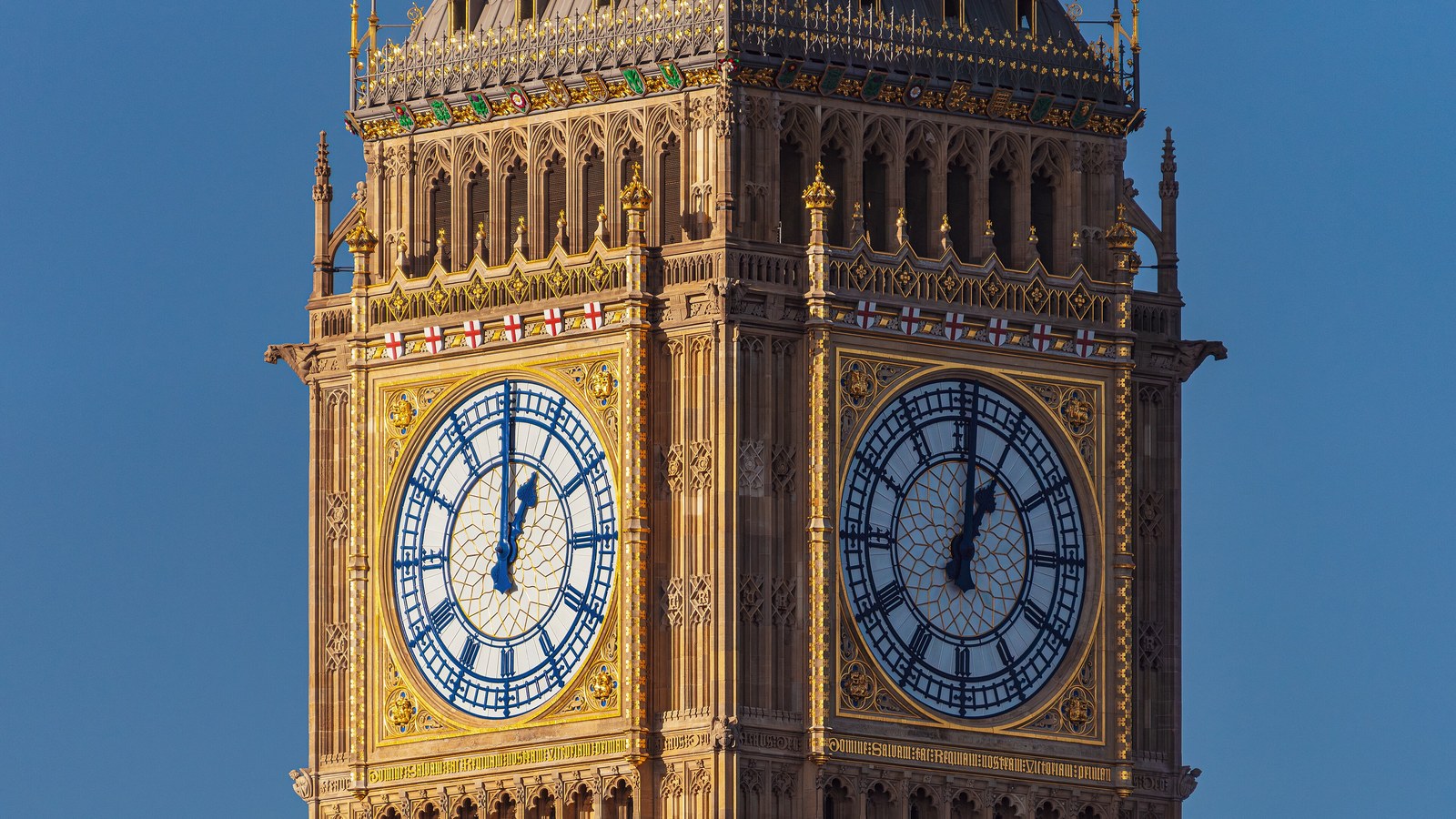 Two clock faces and ornate stonework on Elizabeth Tower at the Palace of Westminster in London, photographed in November 2023.