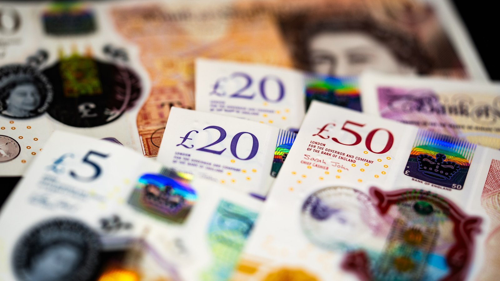 British pound notes in £5, £20 and £50 denominations.