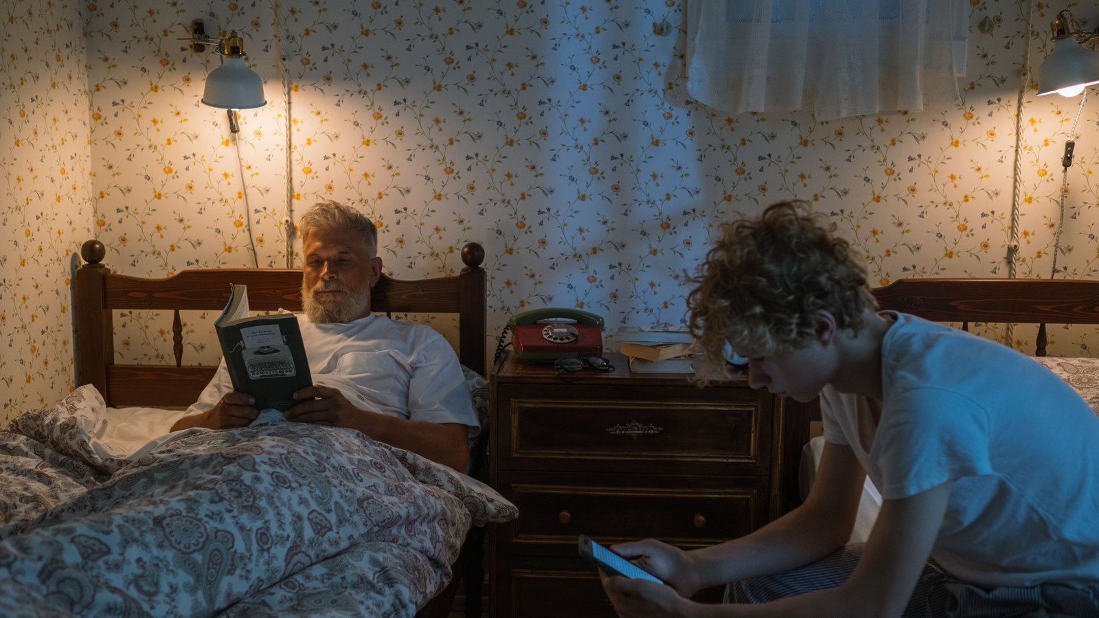 A person using a phone in a darkened room at night.