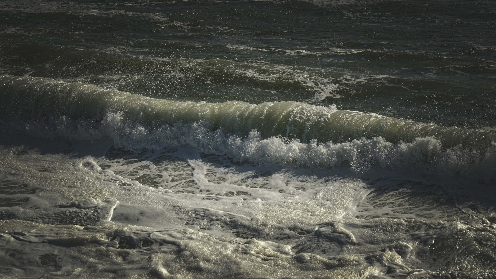 A photograph illustrating dark open ocean swell.