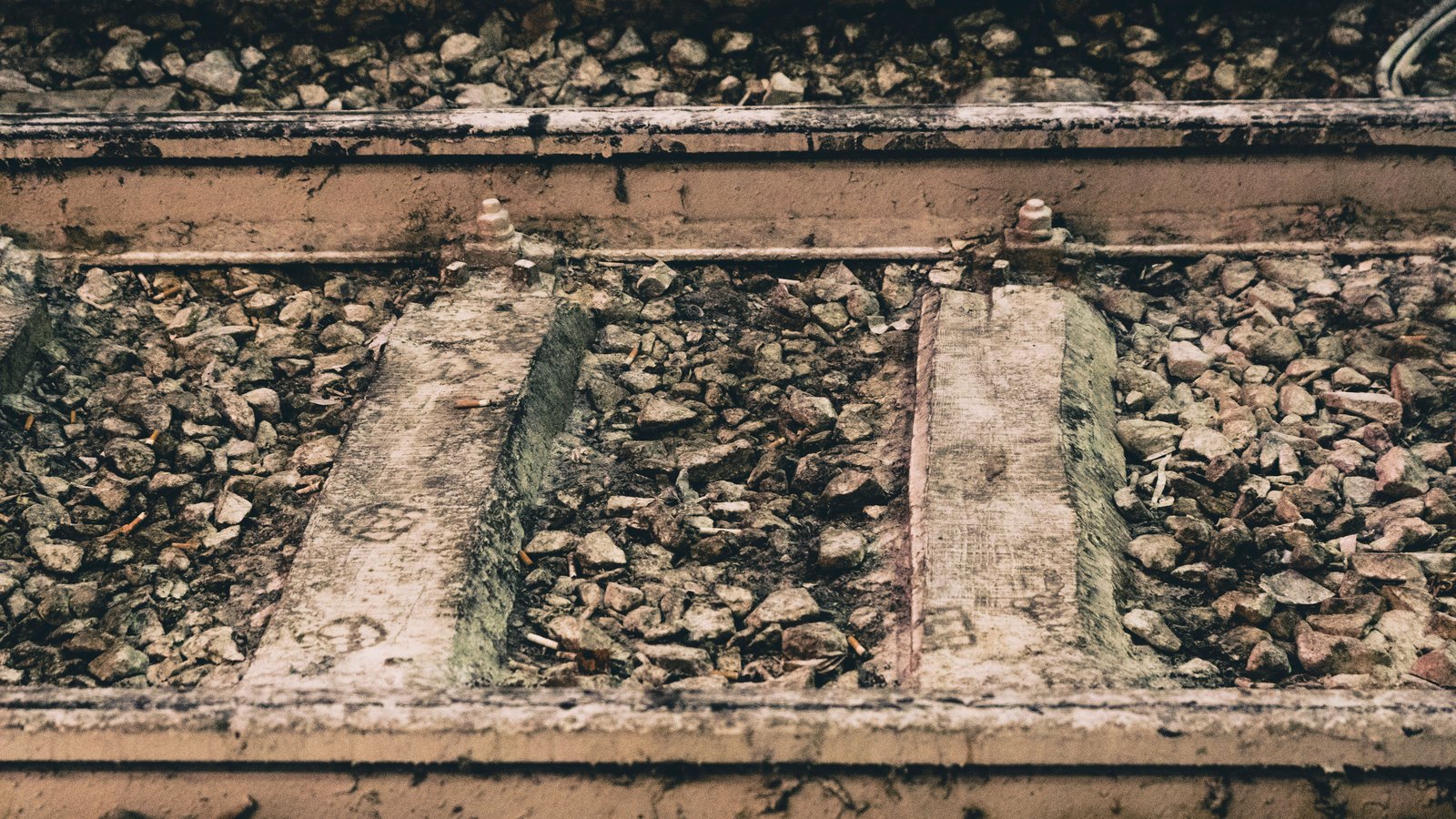 A photograph illustrating railroad track ballast stones macro.