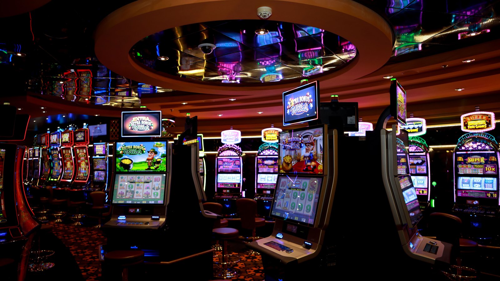 Rows of illuminated slot machines on a casino floor. A generic illustration, not the Cape Coral location.