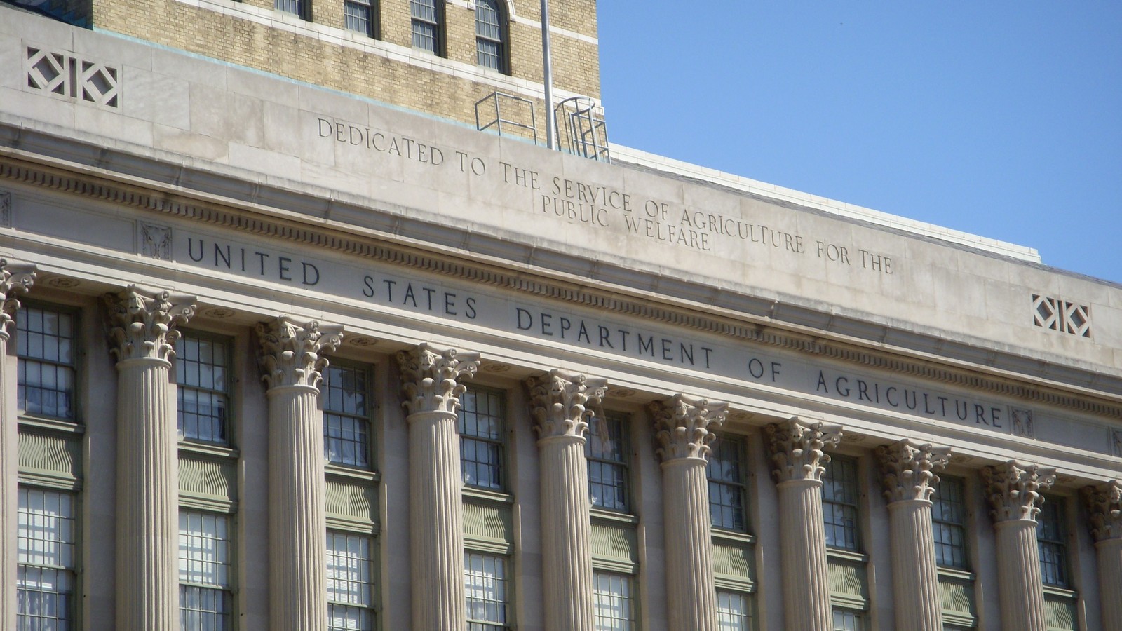 The white marble facade and Corinthian columns of the Jamie L. Whitten Building, headquarters of the U.S. Department of Agriculture in Washington.