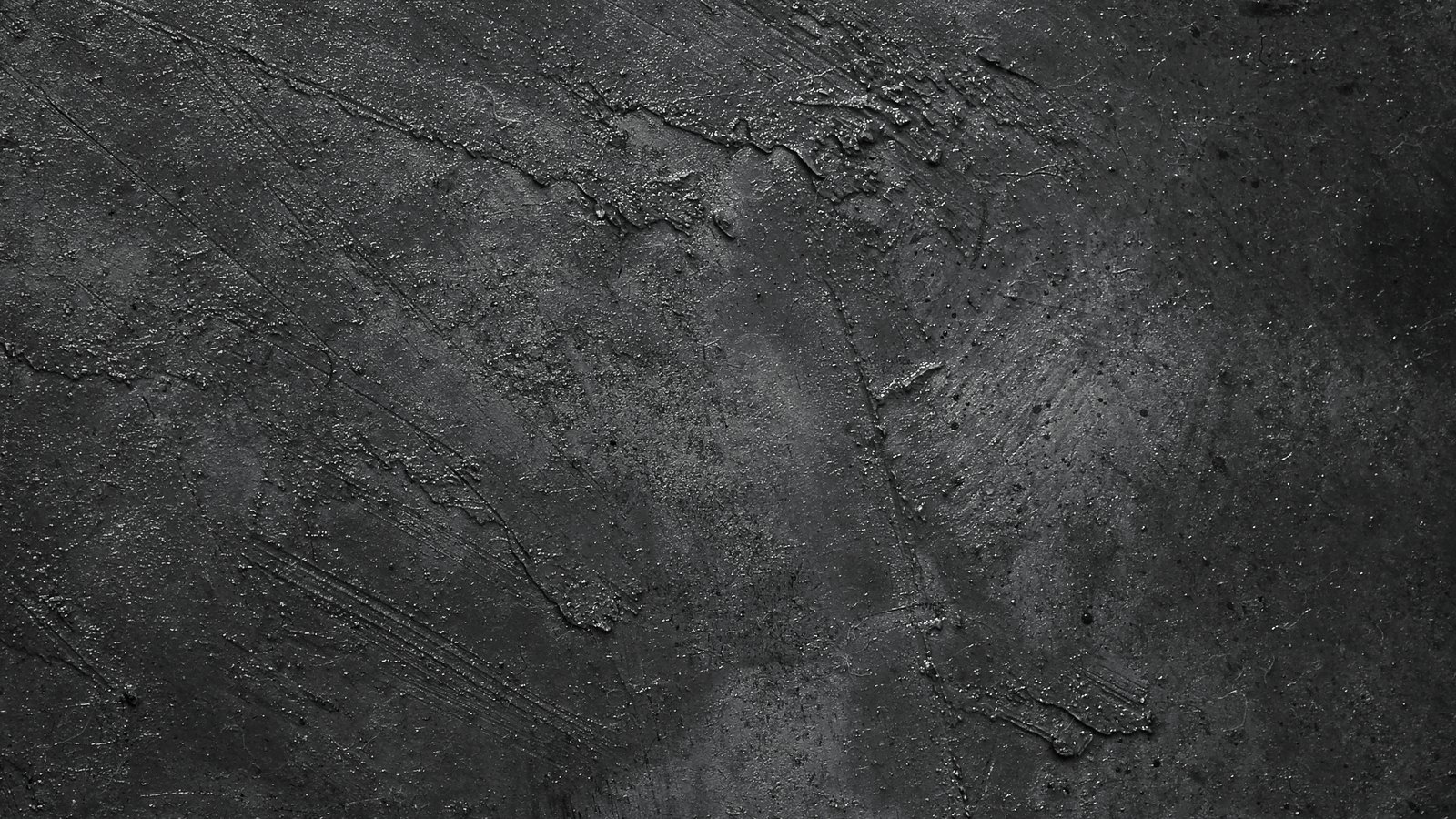 A close crop of a plain dark grey concrete surface, rough and unevenly troweled, filling the whole frame. No text, signage, lettering, vehicle, person, emergency service or identifiable place is visible. A plain surface illustration, not a photograph of White Boulevard, of 31st Street Southwest, of Golden Gate Estates or of the crash, and not evidence about the condition of any road.