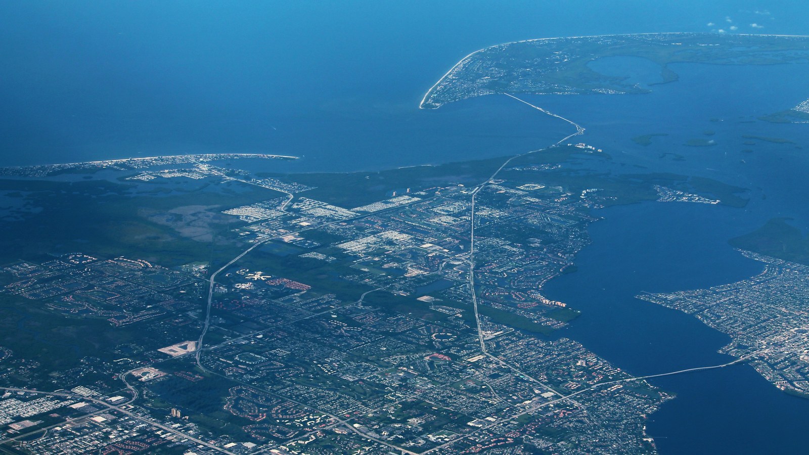 A September 2017 aerial view of the Fort Myers and Sanibel coastline, with neighborhoods, waterways and the Sanibel Causeway.