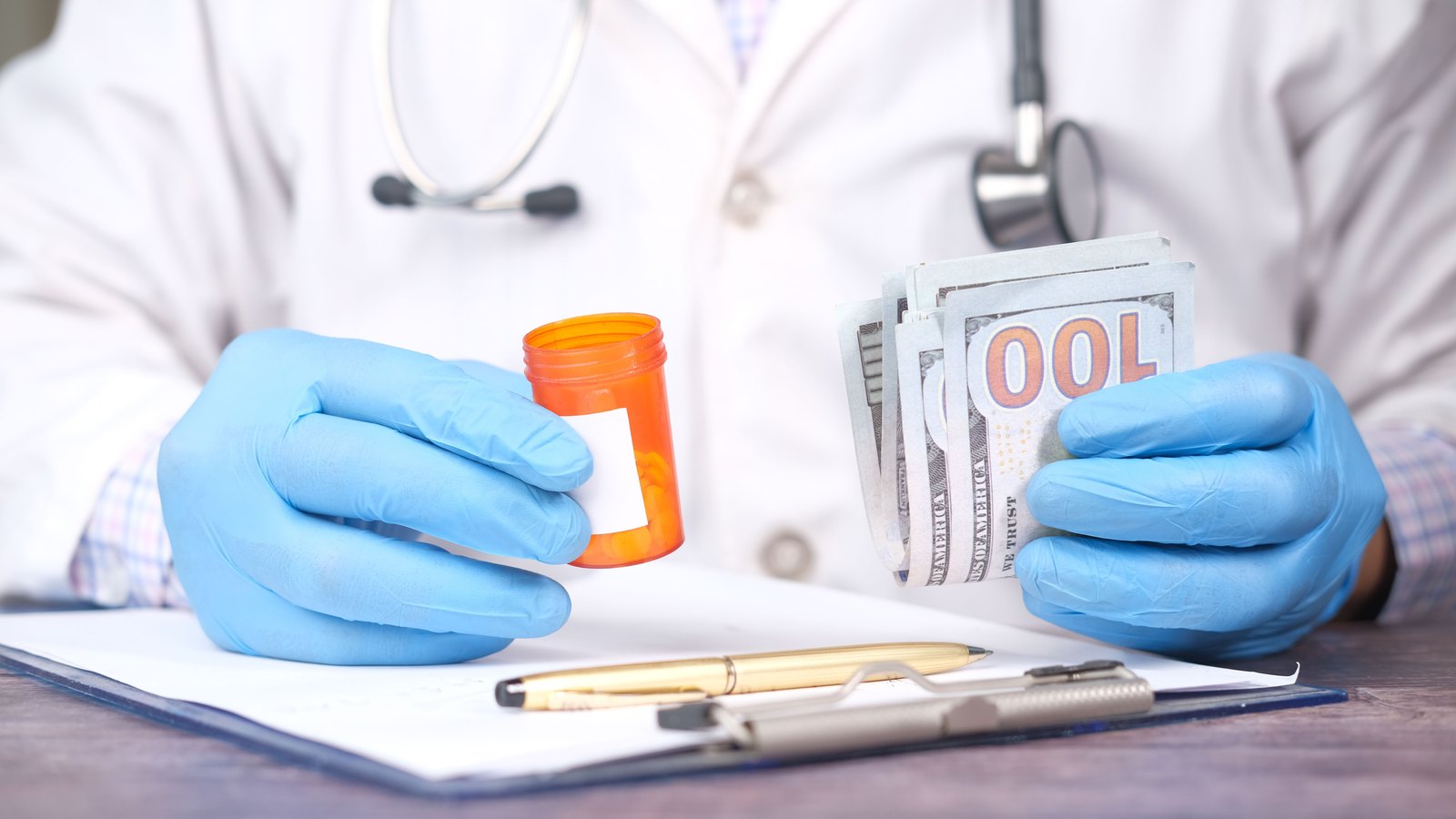 A medical professional in blue gloves holding a prescription bottle and a stack of dollar bills.